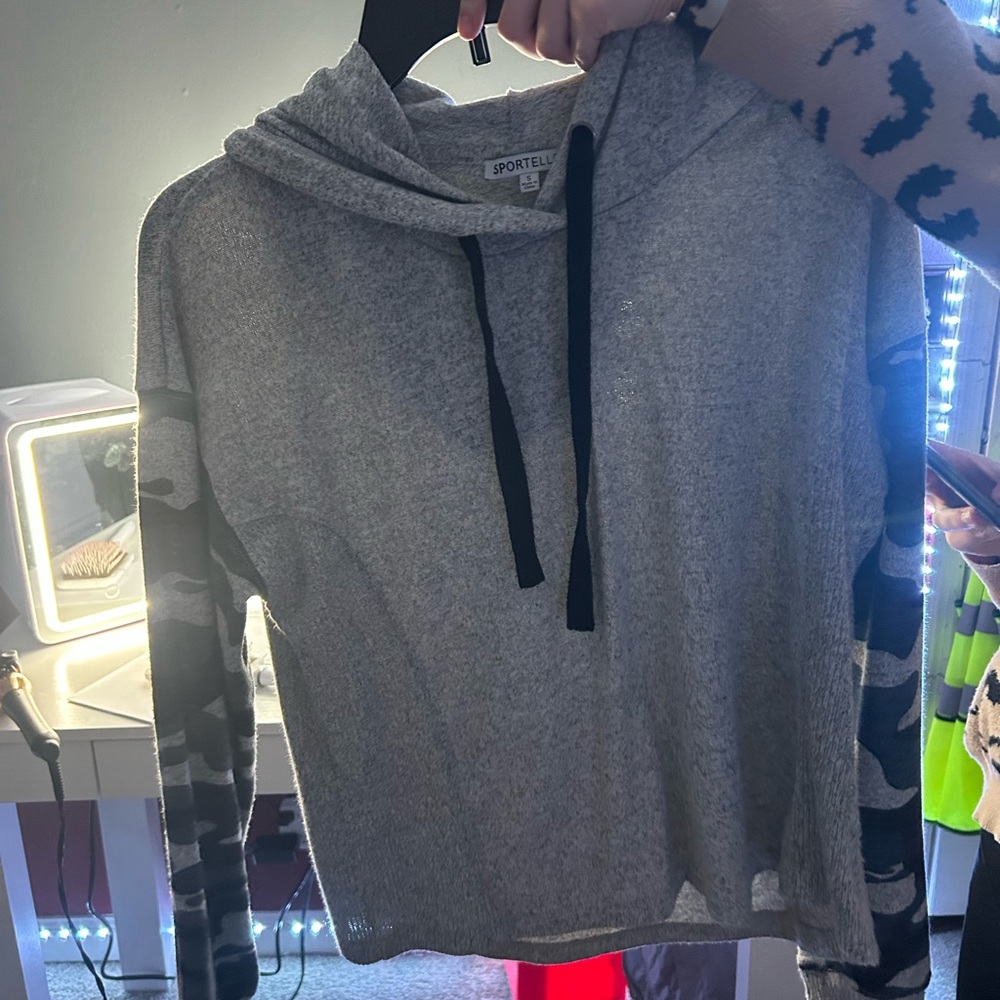 This is a grey pullover/shirt with camo sleeves size small. Can fit size 2/4